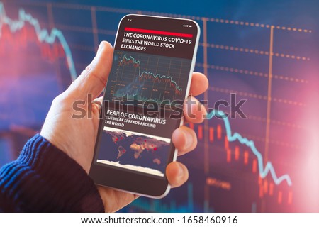 The coronavirus sinks the global stock exchanges. Smartphone app showing the collapse of the stock market due to the global Coronavirus virus crisis. Royalty-Free Stock Photo #1658460916