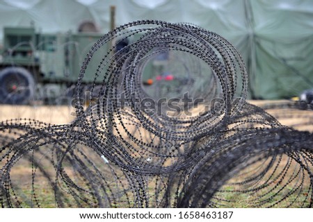 Military barbed-wire fence installed military area.