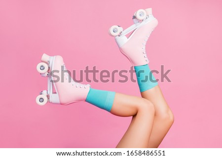 Cropped close-up profile side view of nice attractive lovely perfect feminine long legs wearing blue socks skates skating walking in air isolated over pink pastel color background Royalty-Free Stock Photo #1658486551