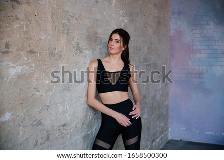 Beautiful fitness model girl posing wearing sport clothes. Girl in the sport concept.