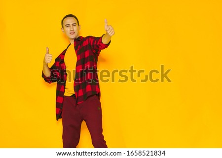 Unbuttoned plaid shirt and a man in a yellow T-shirt