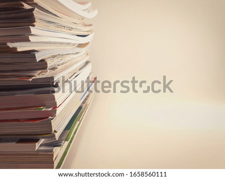 Stack of magazines on a light background.