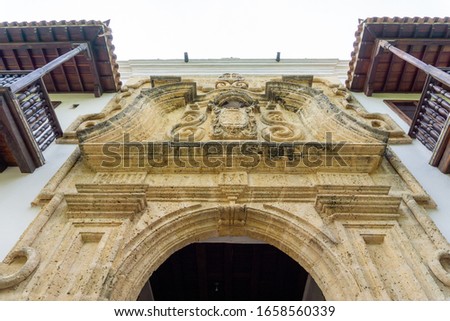 Low angle view of beautiful cast stone carved wall relief on entrance doors to the Palace of Inquisition in Cartagena, Colombia. Royalty-Free Stock Photo #1658560339
