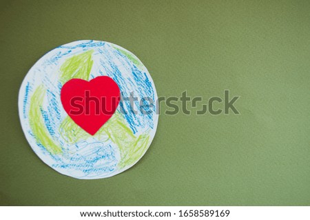 Red heart on the planet. World harmony day, green world environment, day together concept.