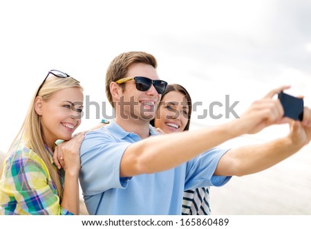 summer, holidays, vacation and happiness concept - group of friends taking selfie with smartphone