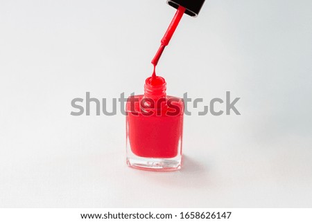 nail polish drop over bottle on white background