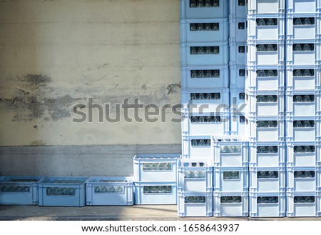 Stack crate of water bottle in warehouse by old grunge wall Royalty-Free Stock Photo #1658643937