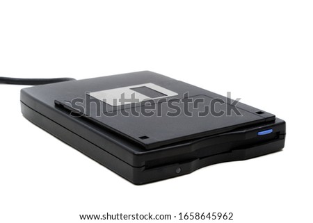 A 3.5" floppy disk and drive isolated on a white background