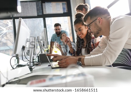 Group of team workers and programmers starting a new project.Senior programmer giving help to beginner. Royalty-Free Stock Photo #1658661511