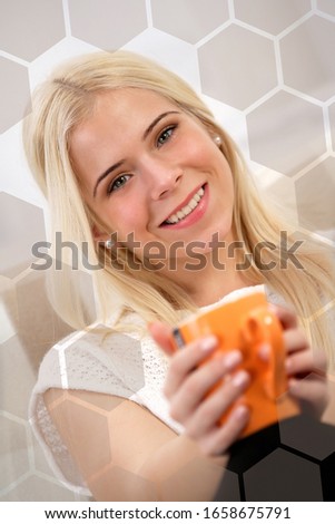 Woman sitting on the sofa, holding a cup of tea