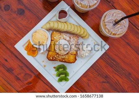 Top view Ice cream and coffee ice tea fruit on a new wooden table