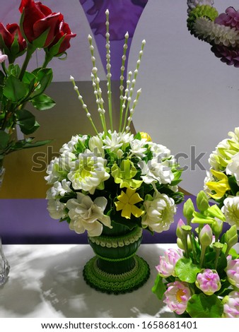 Handmade clay bouquet of various kind of flowers, lotus, jasmine, bouquet arranged in green vase