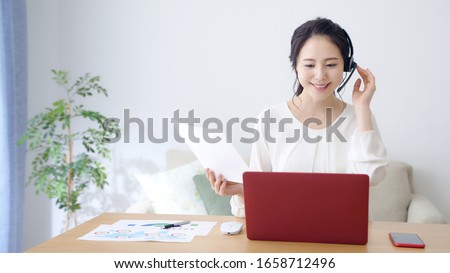 Working asian woman in the living room. Telemeeting. Video conference. Remote work. Royalty-Free Stock Photo #1658712496