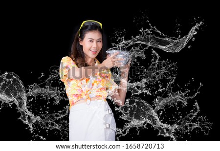 Thai girl smiling Asian beauty Swimming with ancient bowls Preserve the good culture of Thai people during Songkran festival. Thai New Year, Family Day in April