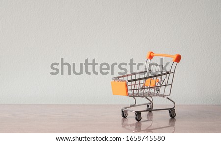 Shopping trolley on table with some copy space. Shopping concept. Free space for create idea.