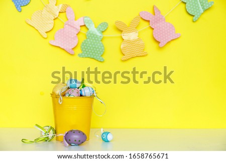 Yellow easter theme, colorful decorations on a white table. 
