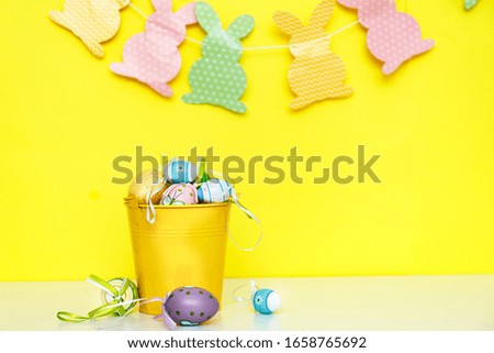 Yellow easter theme, colorful decorations on a white table. 