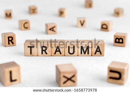 Trauma - words from wooden blocks with letters, physical or mental injury trauma concept, white background Royalty-Free Stock Photo #1658773978