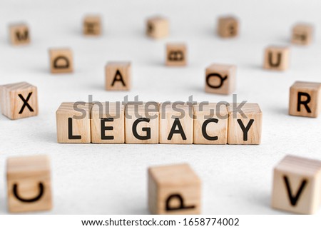 Legacy - words from wooden blocks with letters, money or property left to someone legacy concept, white background Royalty-Free Stock Photo #1658774002