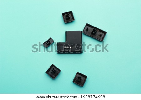 Replacement Laptop Keys. laptop keyboard pieces on blue table. keyboard broken pieces. Royalty-Free Stock Photo #1658774698