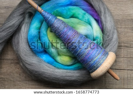 Beautiful handspun yarn, spun on a wooden, traditional handspindle. Royalty-Free Stock Photo #1658774773