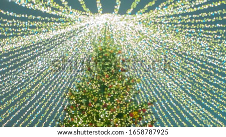 Xmas tree. Blurred background, bokeh. Blurred Christmas tree and lights. Holiday decorated. New year and festive mood.Happy new year atmosphere. Template.Place for text.