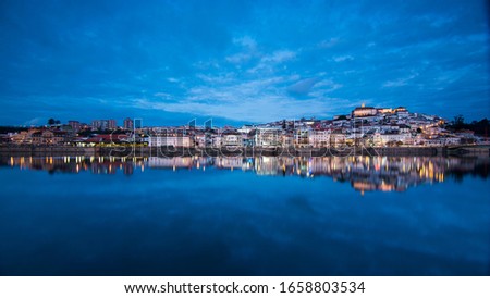 Coimbra with a perfect mirror on the Mondego river Royalty-Free Stock Photo #1658803534
