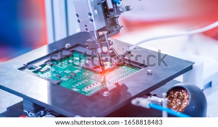 soldering iron tips of automated manufacturing soldering and assembly pcb board Royalty-Free Stock Photo #1658818483