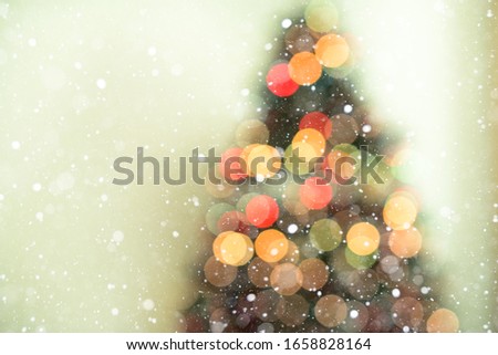 Bokeh christmas tree background with snowfall - defocused lights