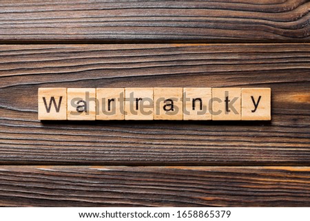 warranty word written on wood block. warranty text on table, concept.