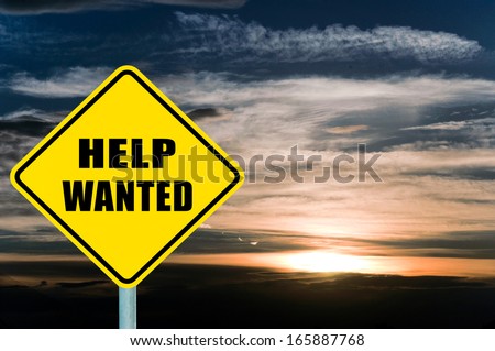 Help wanted yellow road sign with clouds and sky in background