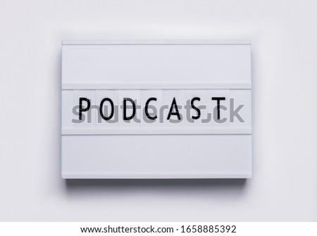 lightbox board on a white background with the words podcast in black letters.