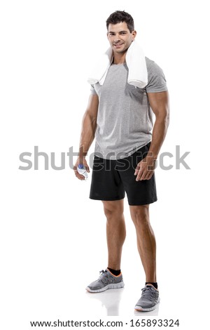 Portrait of a athletic man after doing exercises and holding a bottle of water, isolated over a white background Royalty-Free Stock Photo #165893324