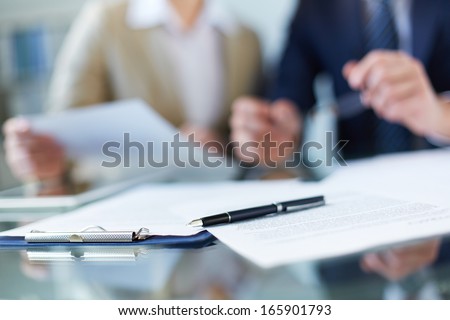 Business documents and pen at workplace
