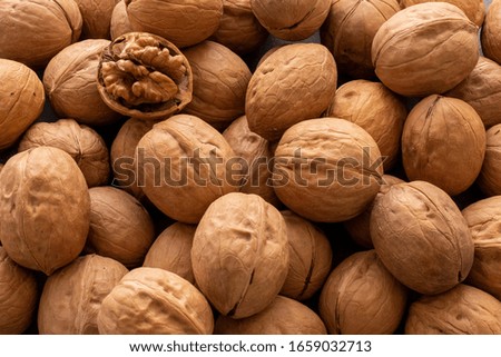 Walnut and walnut kernel. Top view of walnuts in nutshells in full screen