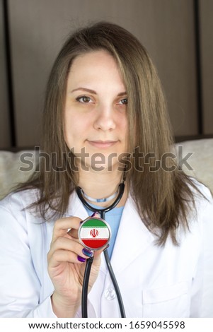 Attractive young female doctor. Focus on the Iran flag stethoscope.