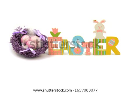 An isolated over white background image of a colorful Easter cutout sign with a purple nest and eggs for the holiday season.