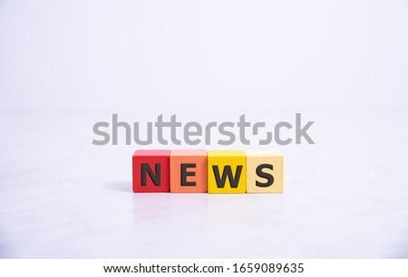 Concept of dices with letters forming word: News. . Dices made from wood with natural imperfections.