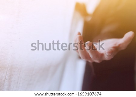 Blurred Photo of Giving a helping hand, asking or offering help close-up shot of a Business man in a business suit.