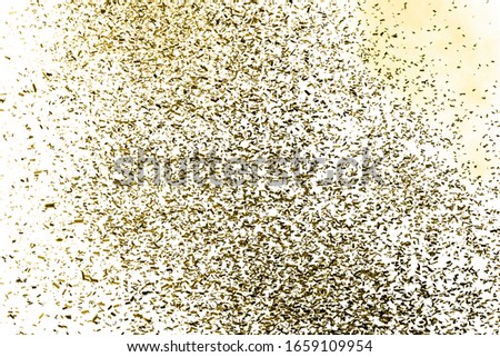 Thousands of confetti fired on air during a festival. Image ideal for backgrounds. Confetti in the picture are golden. White background. Smoke and shades