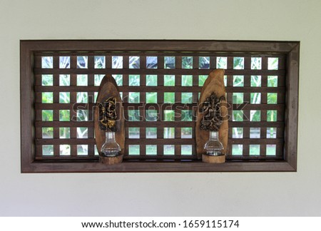 Ganesha figurines decorated on wooden wall.