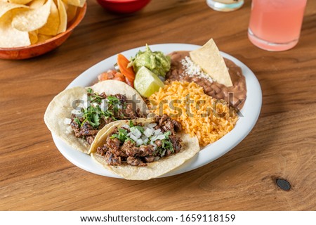 Mexican beef street taco plate served with rice and beans.  Royalty-Free Stock Photo #1659118159