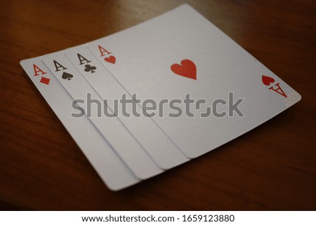 Four aces of playing cards in a row