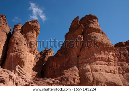 King Solomon's Pillars, weird reddish rocks on the background of deep blue sky in the Timna Valley. The pillars are natural structures that were formed by centuries of water erosion through fractures.