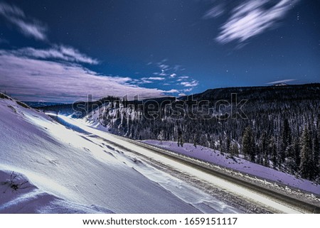 The Alaska Highway in Yukon Territory lit by a full moon. 