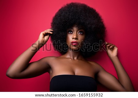black girl with large afro  Royalty-Free Stock Photo #1659155932