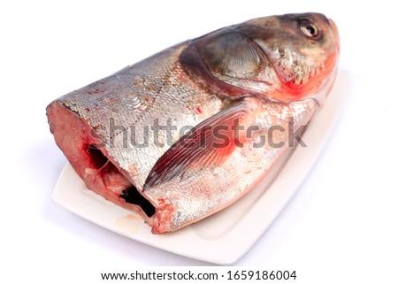 Cut in half with a knife fresh crucian carp  isolated  on white background