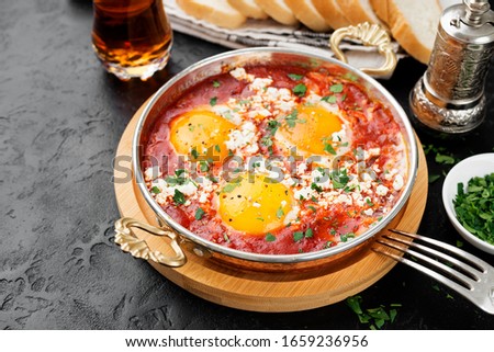 Shakshuka (menemen) fried eggs in tomato sauce for turkish breakfast. Royalty-Free Stock Photo #1659236956