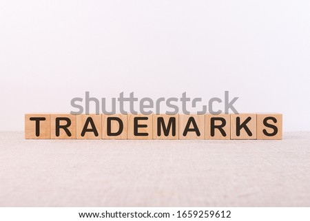 Word Trademarks is written on wooden blocks on a light background.