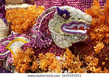 figure of the head of a mythical dragon made of flowers